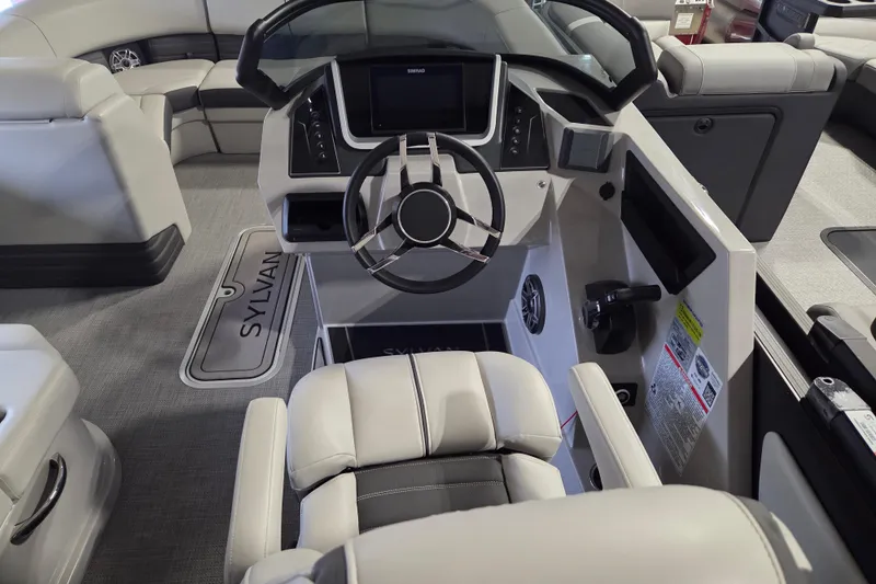 Slide: The Image of 2025 Sylvan G3 CLZ boat interior with modern steering console and luxurious seating. - 7