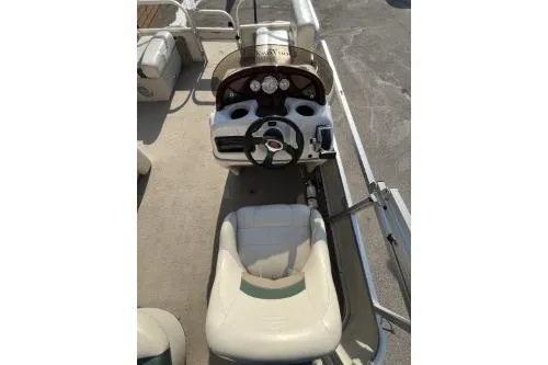 Slide: The Image of 2011 Sun Tracker Party Barge 20 DLX boat interior with steering console and seating. - 3