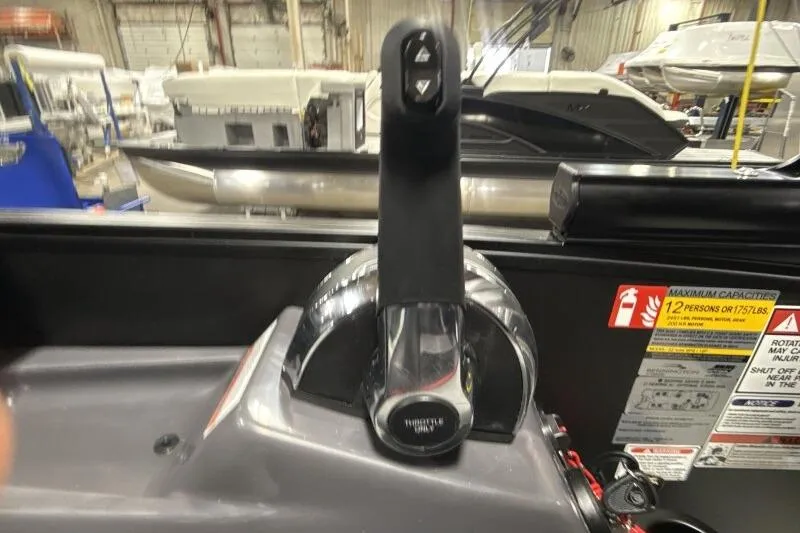 Slide: The Image of Throttle control of a 2026 Bennington 23 MFBSF boat in a showroom setting. - 13