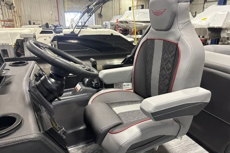 Slide: The Image of Captain's chair and steering wheel of 2026 Bennington 23 MFBSF boat in a showroom. - 14