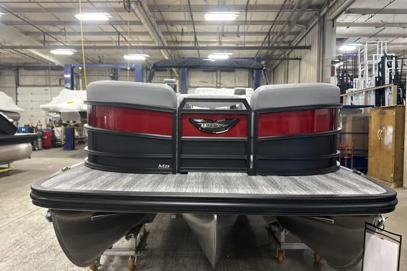 Slide: The Image of 2026 Bennington 23 MFBSF pontoon boat in a factory setting, rear view. - 3