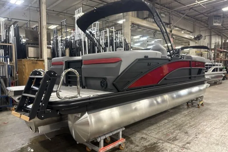 Slide: The Image of 2026 Bennington 23 MFBSF pontoon boat in a factory setting, showcasing sleek design. - 6