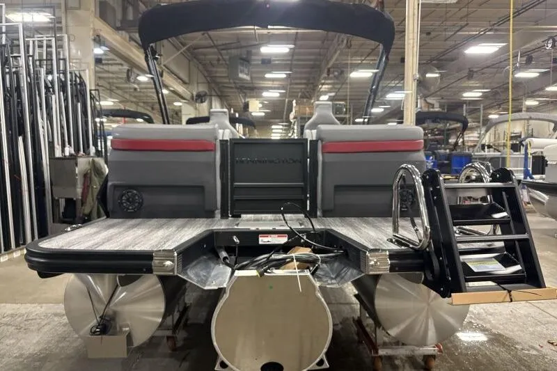 Slide: The Image of 2026 Bennington 23 MFBSF pontoon boat in a factory setting, rear view. - 7
