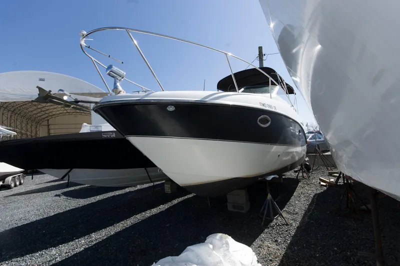 Slide: The Image of 2006 Maxum 2600 SE boat parked on gravel lot. - 28