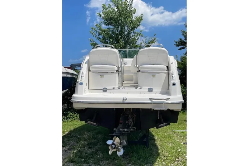 Slide: The Image of 2006 Maxum 2600 SE boat rear view, parked on grass under blue sky. - 31