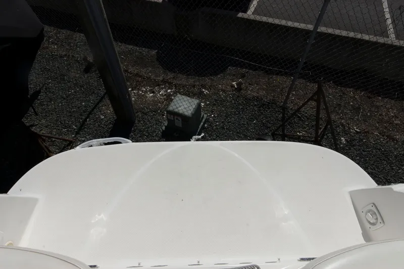 Slide: The Image of Rear view of a 2006 Maxum 2600 SE boat in a parking area. - 32