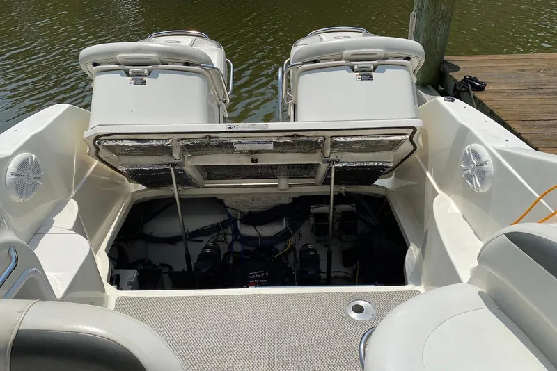 Slide: The Image of Open engine compartment of 2006 Maxum 2600 SE boat docked by water. - 40
