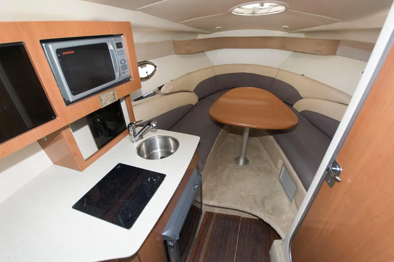 Slide: The Image of Interior of 2006 Maxum 2600 SE with kitchenette and seating area. - 9