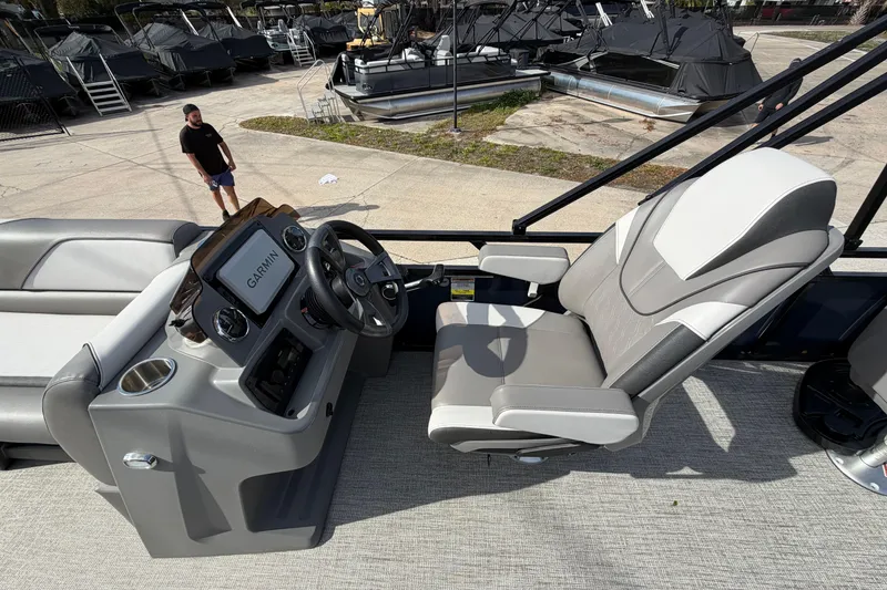 Slide: The Image of 2024 Avalon Venture Fish N Cruise boat interior with steering console and captain's chair. - 5