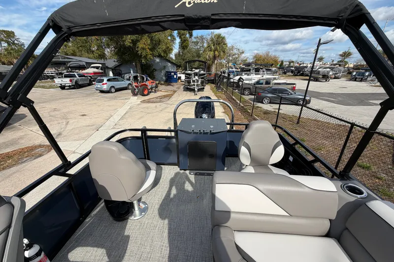 Slide: The Image of 2024 Avalon Venture Fish N Cruise 23' pontoon boat interior with seating and helm. - 6