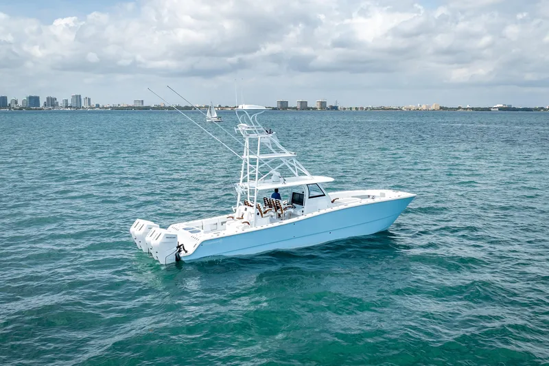 Slide: The Image of 2025 Freeman 43 boat on open water with city skyline in background. - 1