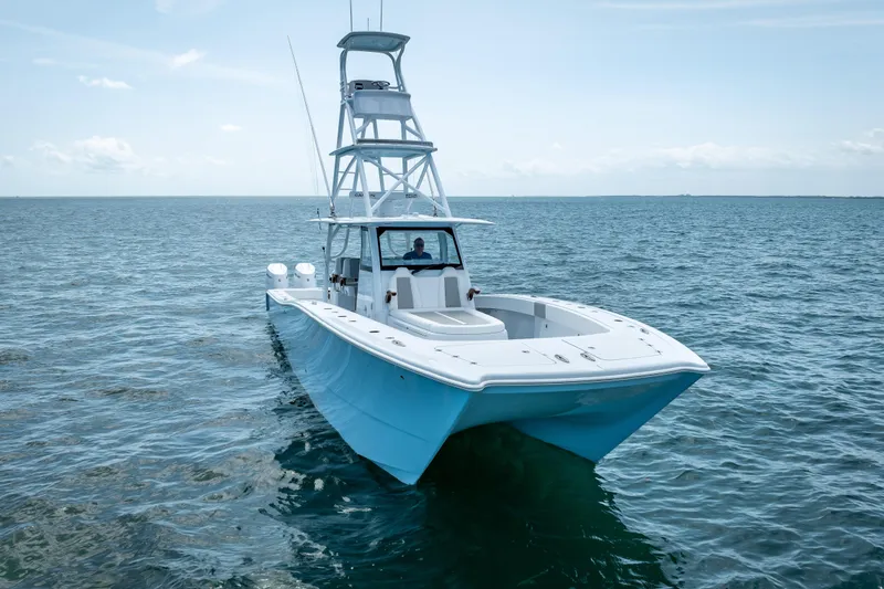 Slide: The Image of 2025 Freeman 43 boat on open sea, featuring sleek design and spacious deck. - 10