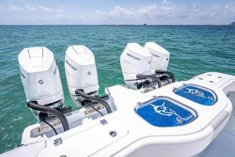 Slide: The Image of Freeman 43 boat with four Mercury Verado engines on open sea, 2025 model. - 102