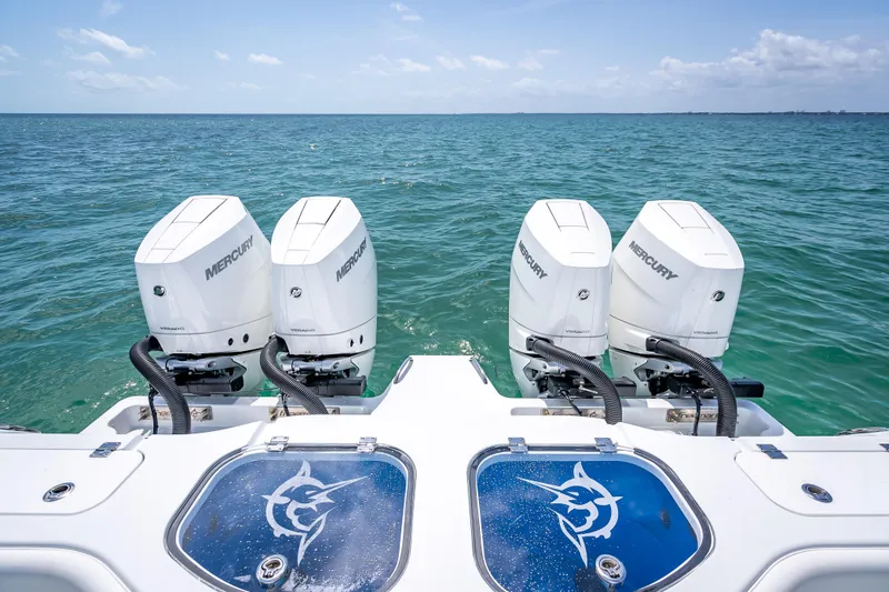 Slide: The Image of Four Mercury outboard engines on a 2025 Freeman 43 boat, ocean backdrop. - 103