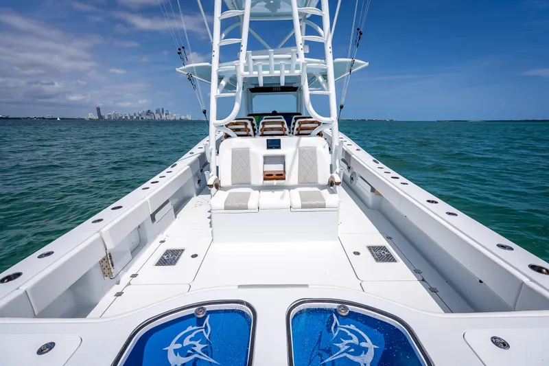 Slide: The Image of 2025 Freeman 43 boat on open water with city skyline in background. - 106