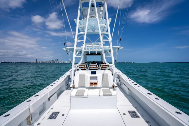 Slide: The Image of 2025 Freeman 43 boat on open water with city skyline in background. - 107