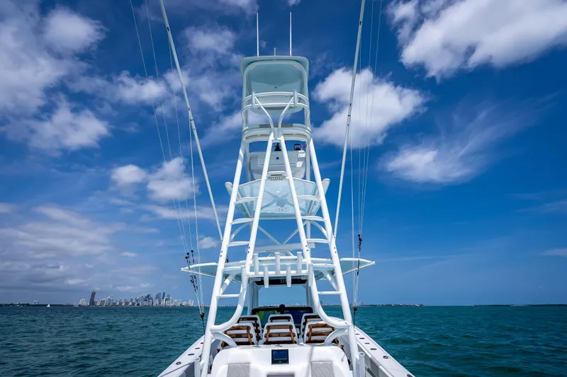 Slide: The Image of Freeman 43 boat on open water, clear sky, city skyline in background, 2025 model. - 108