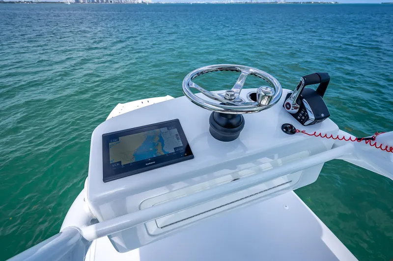 Slide: The Image of Helm of 2025 Freeman 43 boat with navigation system and controls on open water. - 116