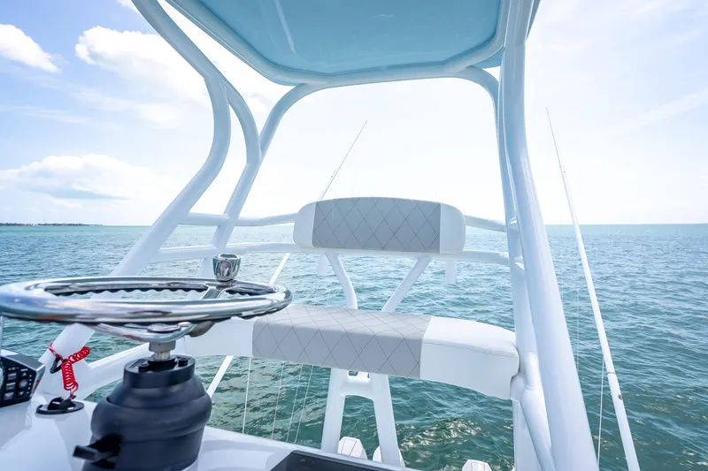 Slide: The Image of 2025 Freeman 43 boat helm with ocean view, featuring modern steering and seating. - 118