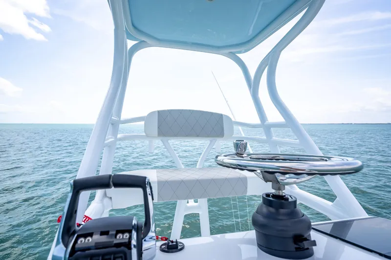 Slide: The Image of 2025 Freeman 43 boat helm with ocean view, featuring modern steering and controls. - 119