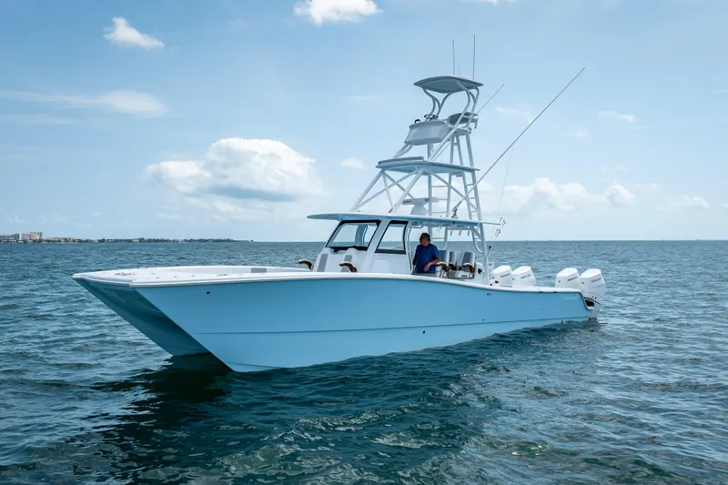 Slide: The Image of 2025 Freeman 43 boat on open water, clear sky, multiple outboard engines. - 13