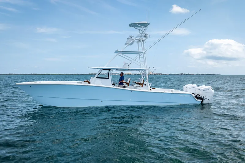 Slide: The Image of 2025 Freeman 43 boat on open water, clear sky, side view. - 15