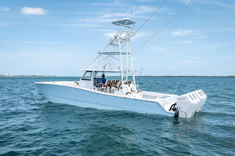 Slide: The Image of 2025 Freeman 43 boat on open water, featuring dual Mercury engines. - 17