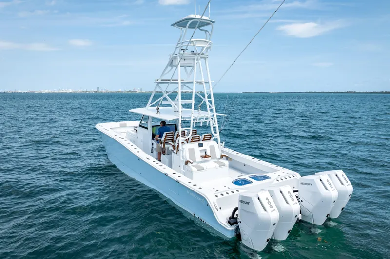 Slide: The Image of 2025 Freeman 43 boat on open water, featuring multiple outboard engines. - 18