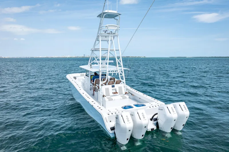 Slide: The Image of 2025 Freeman 43 boat with multiple outboard engines on open water. - 19