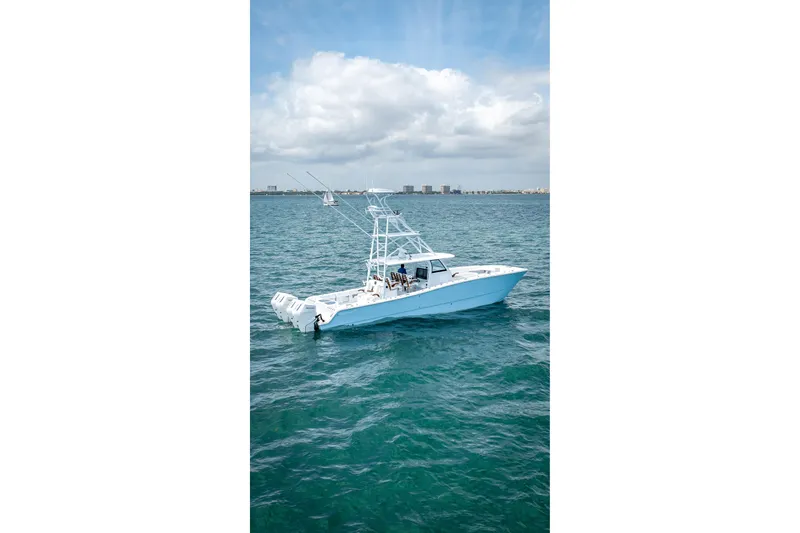 Slide: The Image of 2025 Freeman 43 boat cruising on open water under a partly cloudy sky. - 2