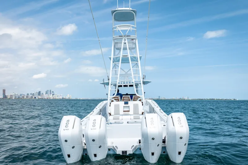 Slide: The Image of Freeman 43 boat with four engines on open water, city skyline in background, 2025 model. - 20