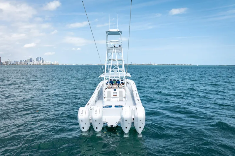 Slide: The Image of 2025 Freeman 43 boat on open water with city skyline in background. - 21