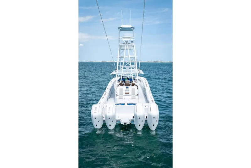 Slide: The Image of Freeman 43 boat, 2025 model, on open water with clear blue sky. - 22