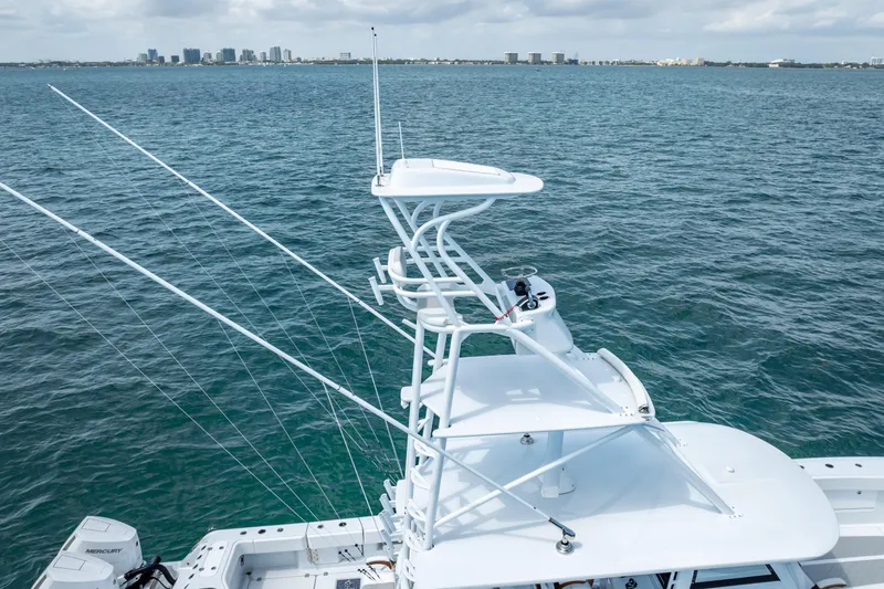 Slide: The Image of 2025 Freeman 43 boat with tower, fishing rods, and ocean backdrop. - 25