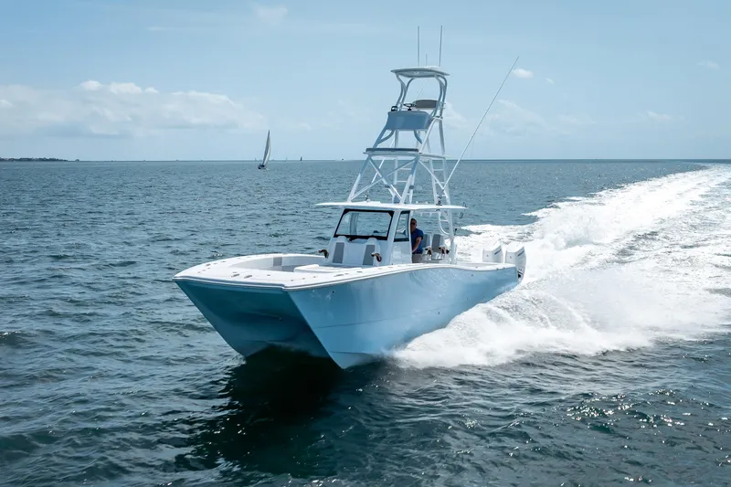 Slide: The Image of 2025 Freeman 43 boat cruising on open water under clear skies. - 32