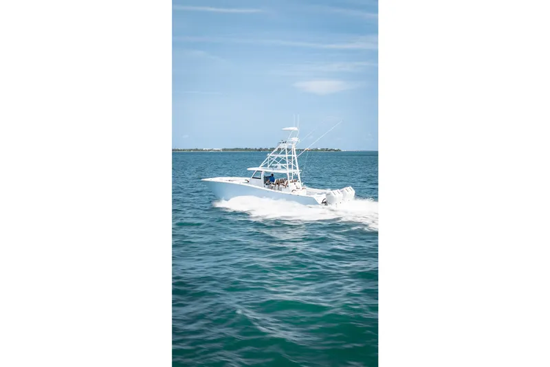 Slide: The Image of 2025 Freeman 43 boat cruising on open water under clear blue sky. - 33