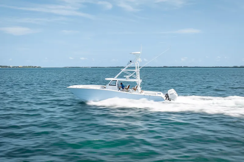 Slide: The Image of 2025 Freeman 43 boat cruising on open water under clear blue skies. - 34