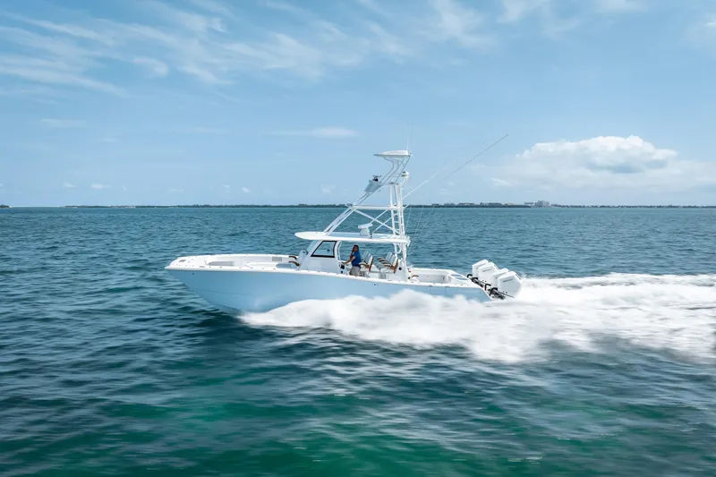 Slide: The Image of 2025 Freeman 43 boat cruising on open water under a clear blue sky. - 36