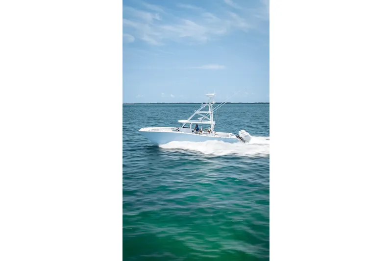 Slide: The Image of 2025 Freeman 43 boat cruising on open water under clear blue sky. - 38