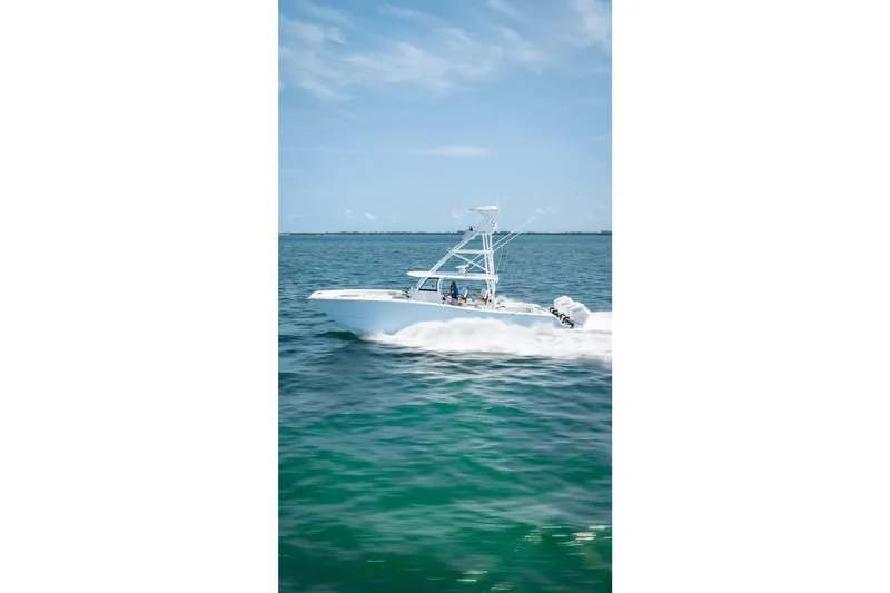 Slide: The Image of 2025 Freeman 43 boat cruising on clear blue ocean waters. - 39