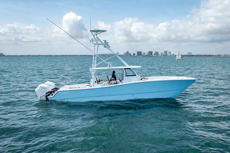 Slide: The Image of 2025 Freeman 43 boat cruising on open water with city skyline in background. - 4