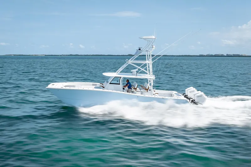 Slide: The Image of 2025 Freeman 43 boat cruising on open water under clear blue skies. - 40