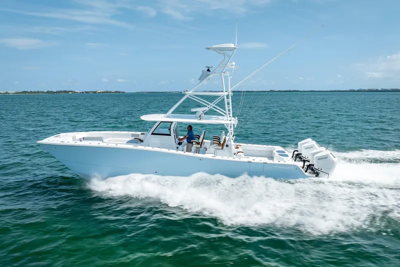 Slide: The Image of 2025 Freeman 43 boat cruising on open water under clear blue skies. - 42