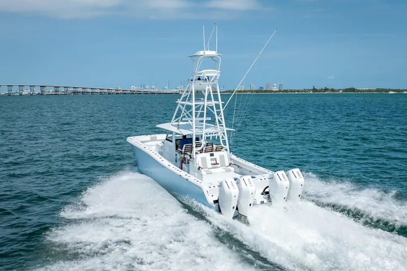 Slide: The Image of 2025 Freeman 43 boat cruising on open water with city skyline in background. - 44