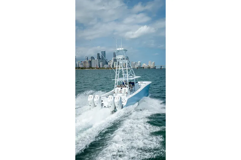 Slide: The Image of 2025 Freeman 43 boat cruising on water with city skyline in background. - 47