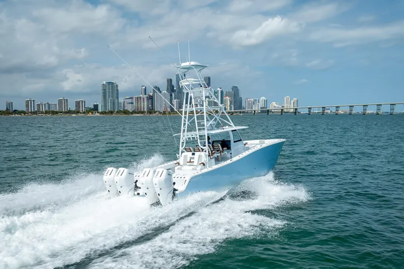 Slide: The Image of 2025 Freeman 43 boat cruising near city skyline and bridge on a sunny day. - 48