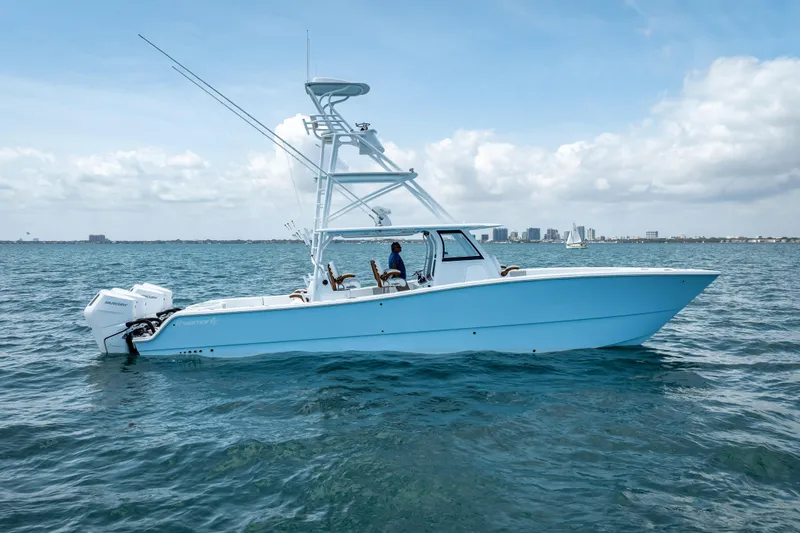 Slide: The Image of 2025 Freeman 43 boat on open water with city skyline in background. - 5