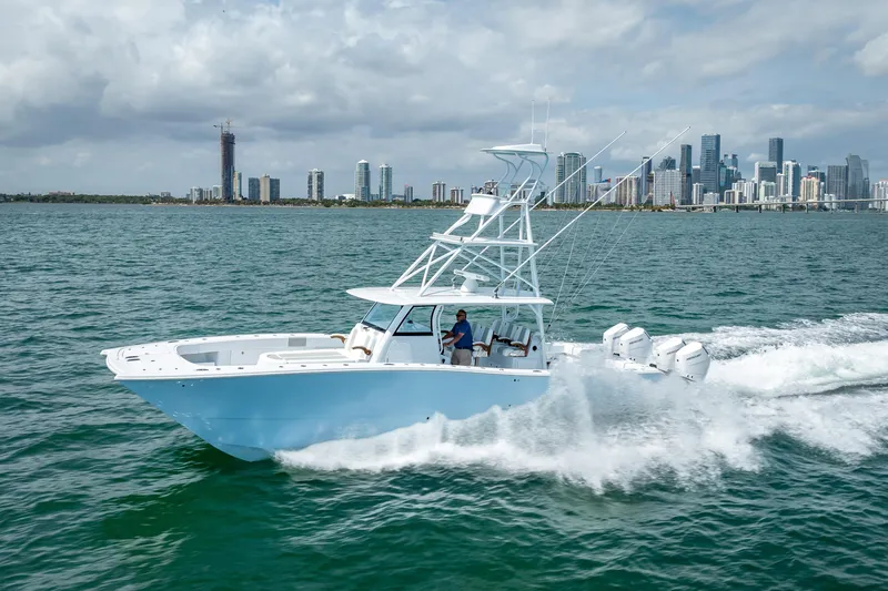 Slide: The Image of 2025 Freeman 43 boat cruising near city skyline on a sunny day. - 50