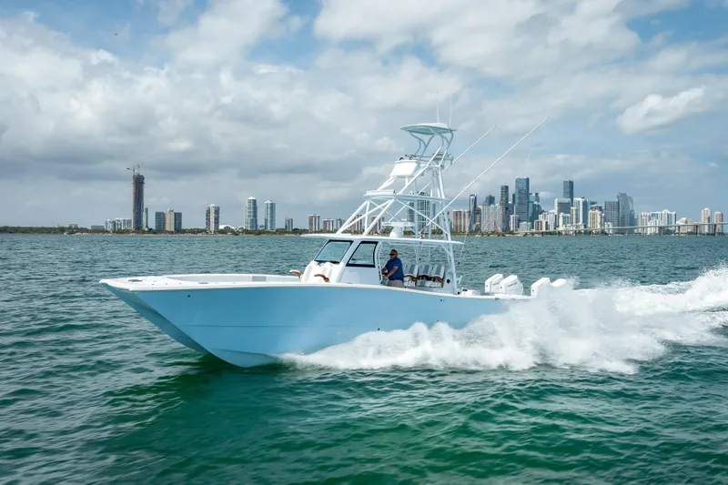 Slide: The Image of 2025 Freeman 43 boat cruising near city skyline on a sunny day. - 51