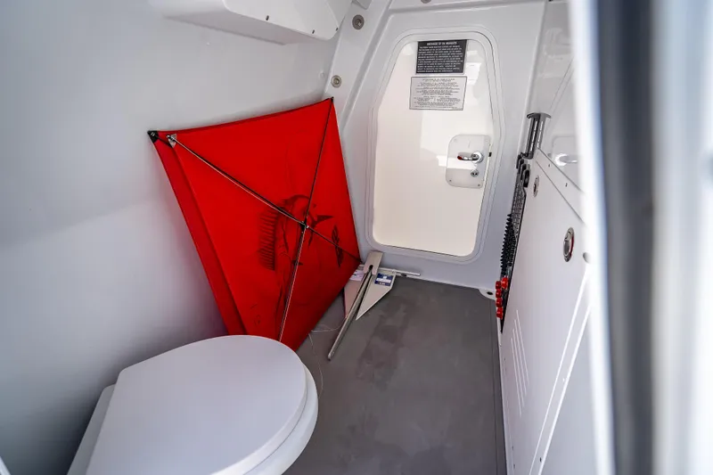 Slide: The Image of Interior of 2025 Freeman 43 boat with toilet, red kite, and storage area. - 53